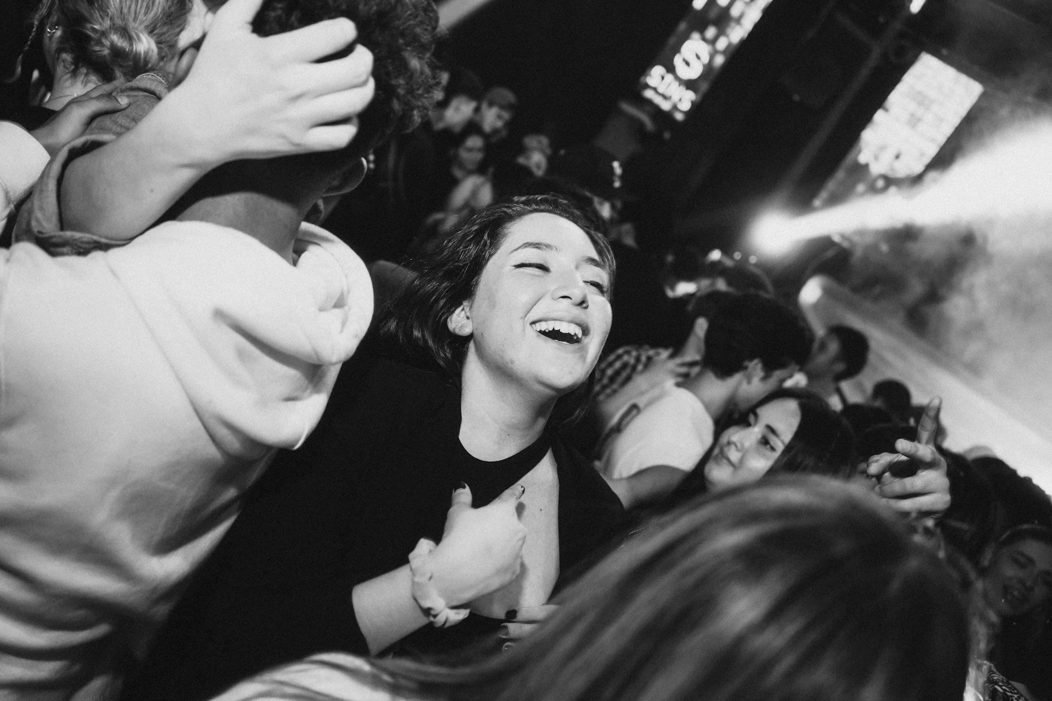 A group of friends enjoying a vibrant nightlife party, captured in black and white.